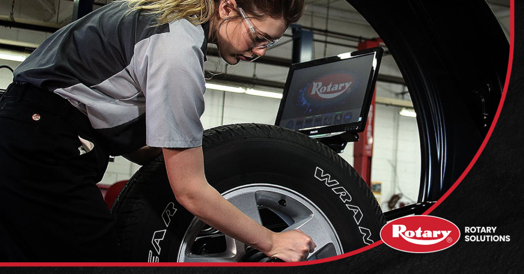 technician with wheel balancer